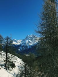 Scenic view of mountains against clear blue sky