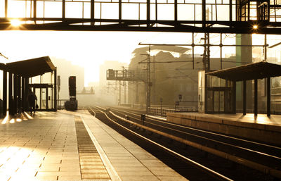 Railroad station in city against sky