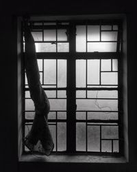 Low section of person standing by window in building
