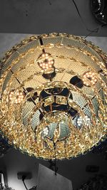 Close-up of illuminated lighting equipment against sky