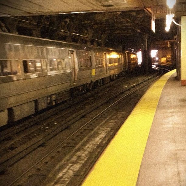 illuminated, transportation, railroad track, night, rail transportation, public transportation, railroad station platform, railroad station, built structure, the way forward, architecture, diminishing perspective, empty, vanishing point, lighting equipment, city, no people, indoors, train - vehicle, building exterior