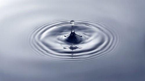 High angle view of drop falling on water