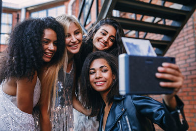 Portrait of smiling young woman using smart phone