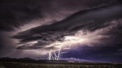 Lightning strike against sky on landscape