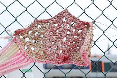 Close-up of fresh chainlink fence against sky