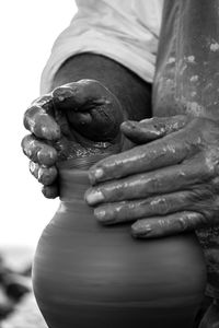 Cropped image of potter molding clay