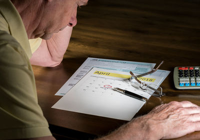 High angle view of man working on table