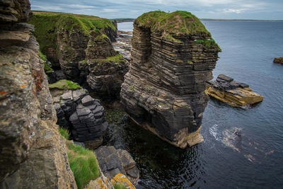 High angle view of rocks on sea shore