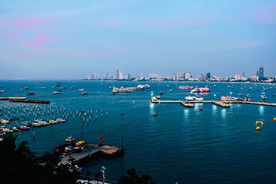 High angle view of harbor in city against sky