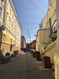 Street amidst buildings against clear sky