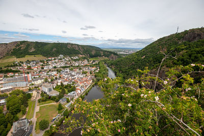 High angle view of townscape by sea against sky