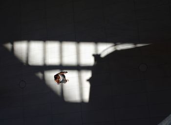 High angle view of woman on tiled floor