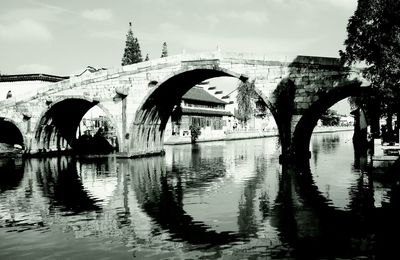 Bridge over river with city in background