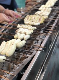 Person preparing food on barbecue grill