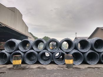 Stack of pipes against sky