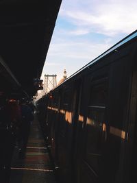 Train at railroad station against sky