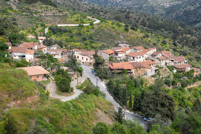 High angle view of houses and trees by village