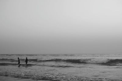 People on beach against sky