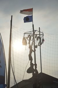 Low angle view of flags hanging against sky