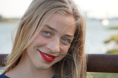 Close-up portrait of smiling young woman