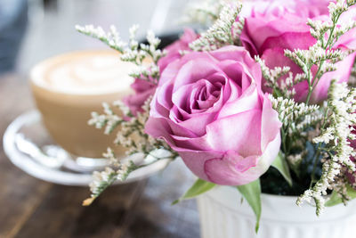 Close-up of pink roses on table