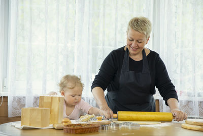 Happy mother and son on table