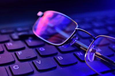 Close-up of eyeglasses on computer keyboard