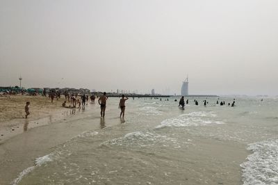 People on beach against sky