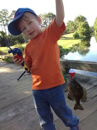 Boy playing with fishing rod in water