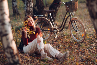 Bicycle sitting on tree by field