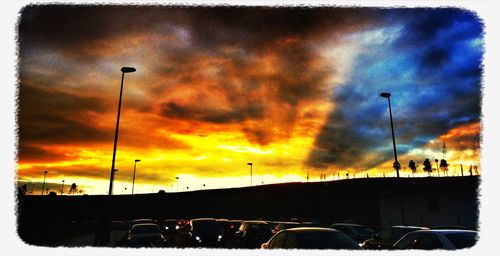 Parking lot against cloudy sky at sunset