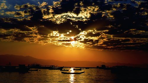 Boat in sea at sunset