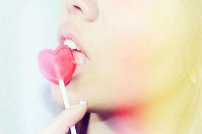 Woman with heart-shaped lollipop