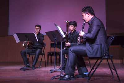 Men playing in music concert