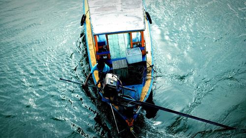 High angle view of men sailing on sea