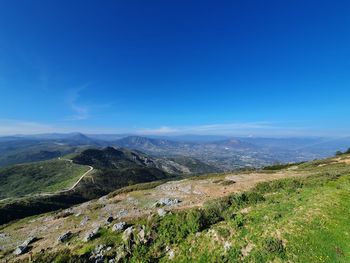 Scenic view of landscape against blue sky