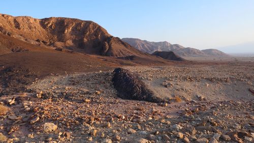 Scenic view of arid desert against sky