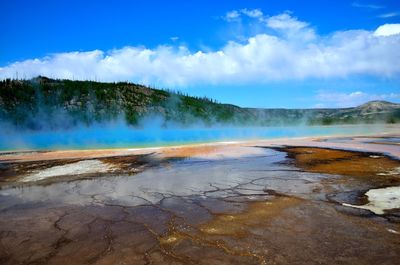 Geyser and mountain against sky