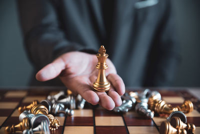 Midsection of man playing chess