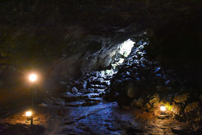 Illuminated rock formation in water at night