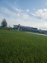 Man standing on field against sky