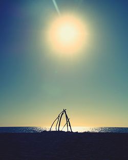 Silhouette of beach against sky during sunset