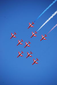 Low angle view of airplanes flying in sky