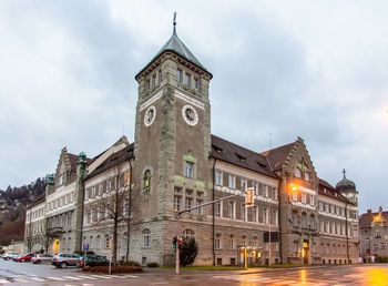 View of buildings in city against cloudy sky