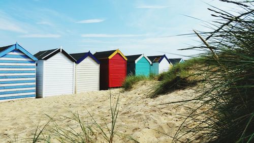 Multi colored umbrellas on beach against sky