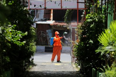 Officers from the dp team care about spraying disinfectant liquid in the halls in makassar city