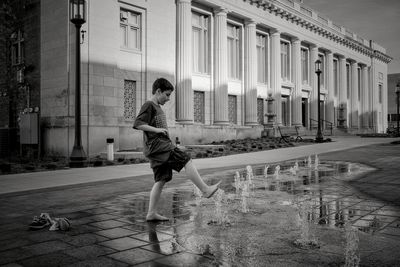 Boy standing against nebraska state capitol building 