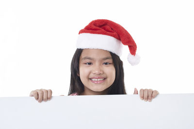Portrait of a smiling girl against white background