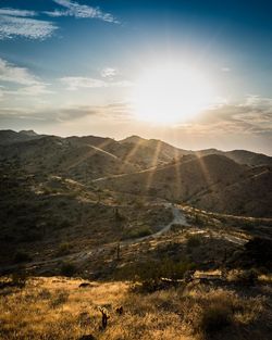 Sunlight streams through the clouds over south mountain in phoenix, arizona.