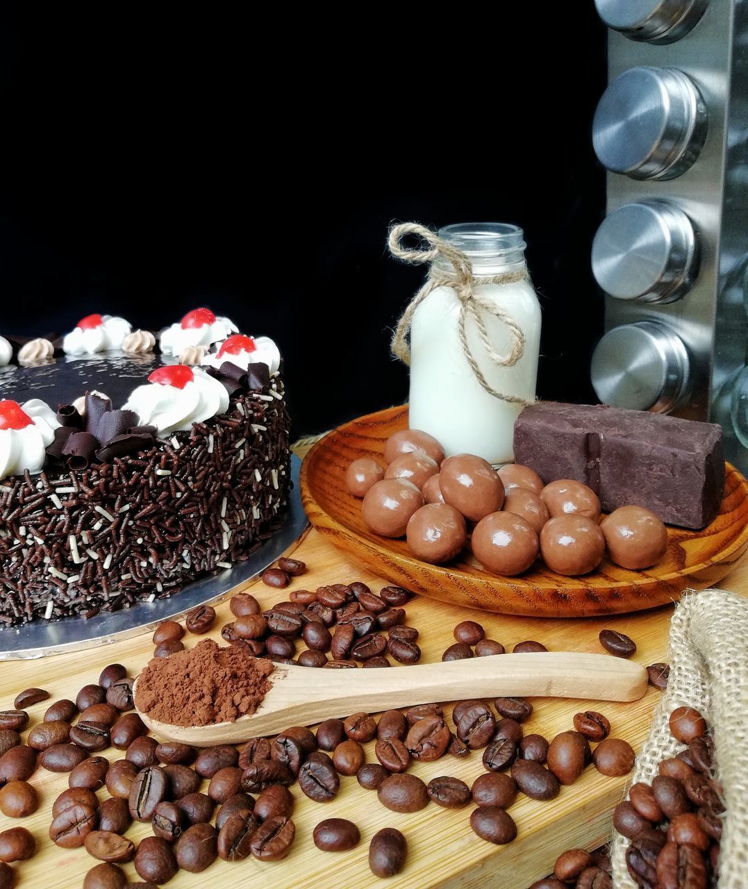 CLOSE-UP OF COFFEE BEANS IN GLASS ON TABLE